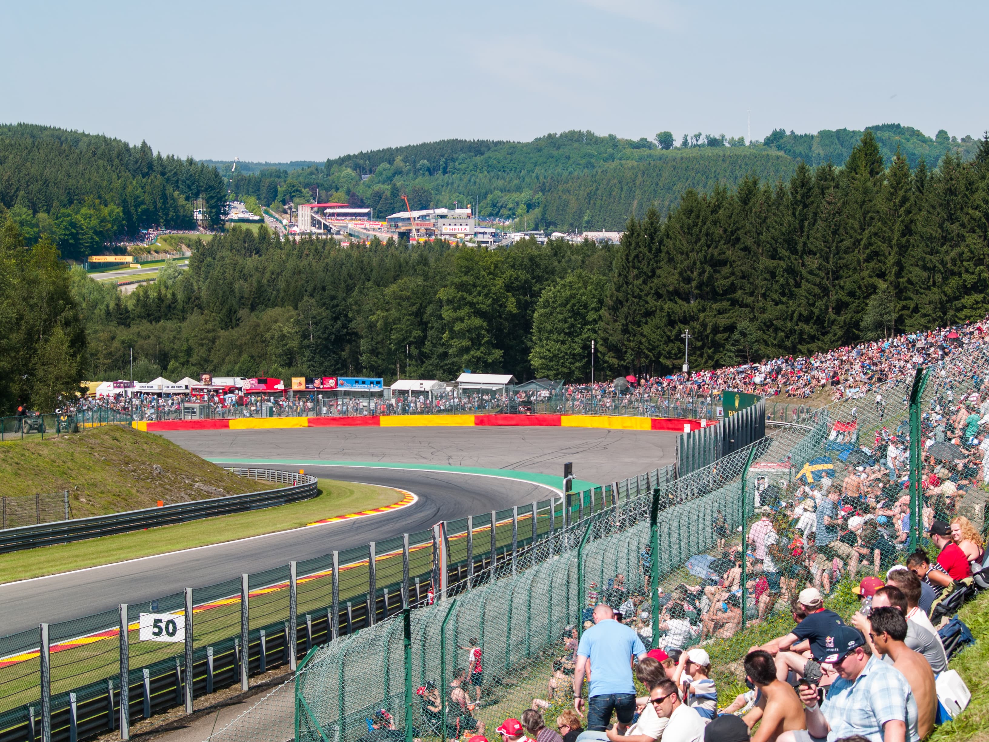 F1 cars navigating the Pouhon double-left corner at Circuit de Spa-Francorchamps
