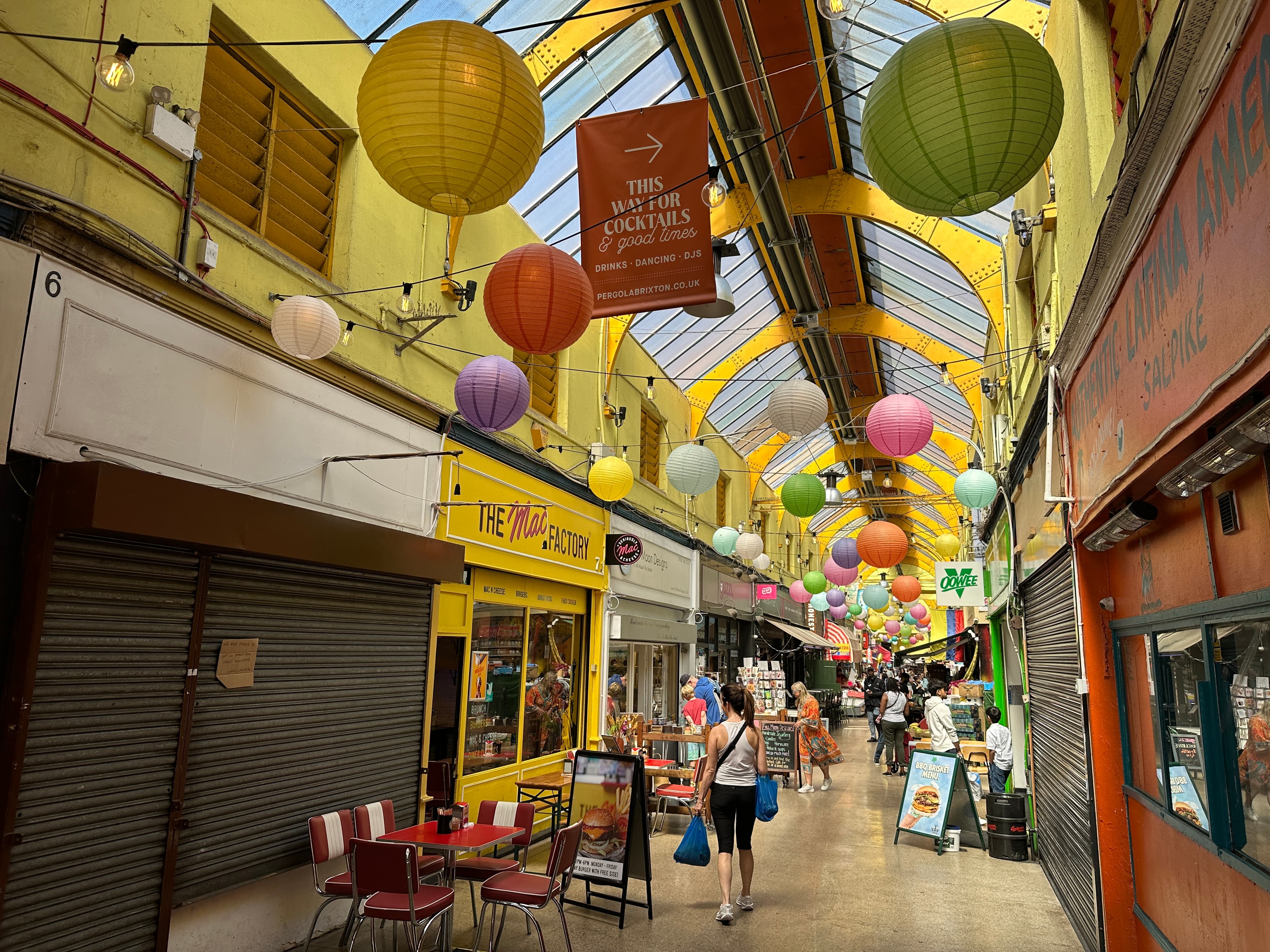 Inside Brixton Village, the covered market arcade in SW9, looking down the central passage