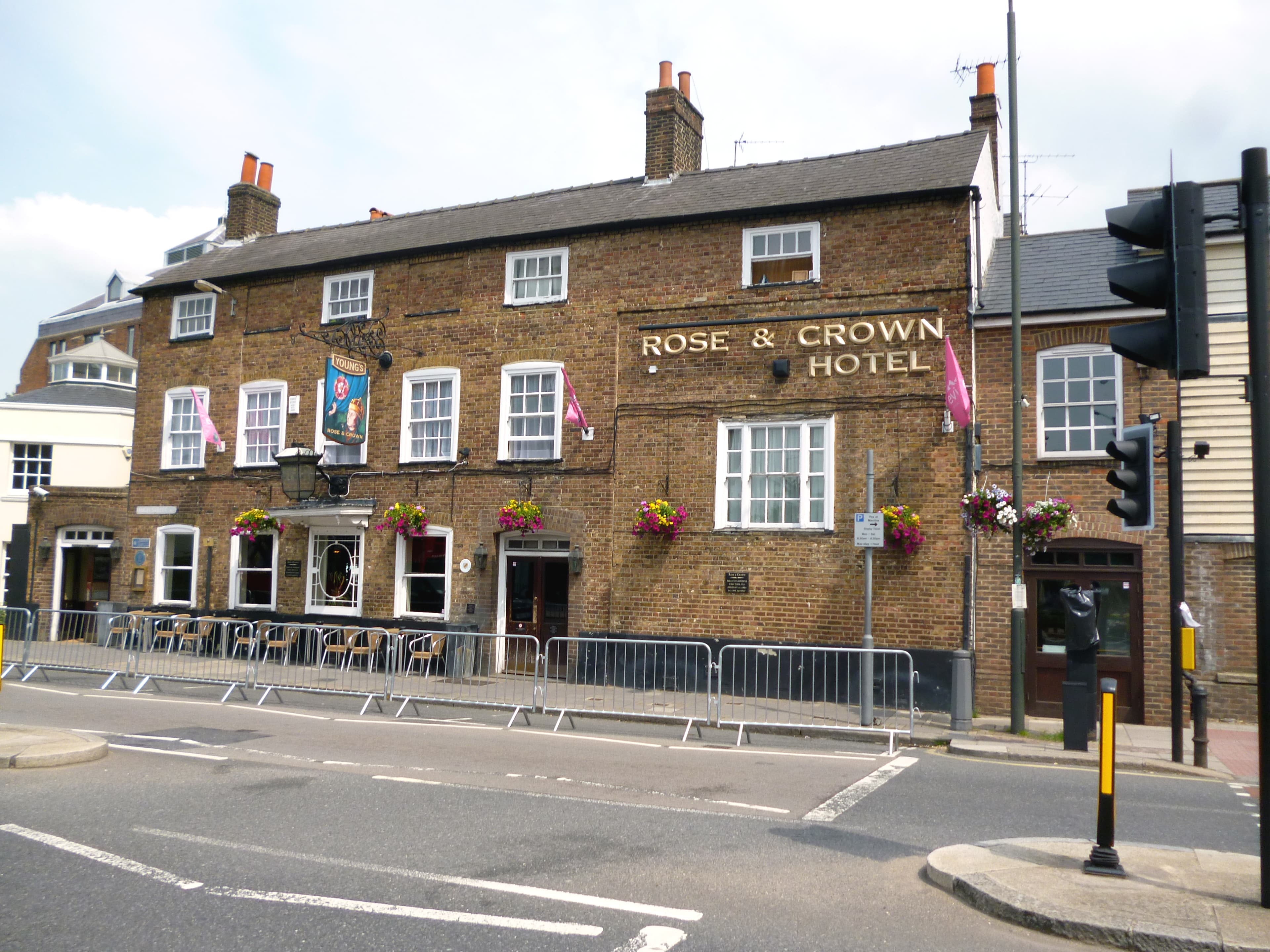 The Rose & Crown pub hotel on Wimbledon Village High Street, a 17th-century building with hanging flower baskets