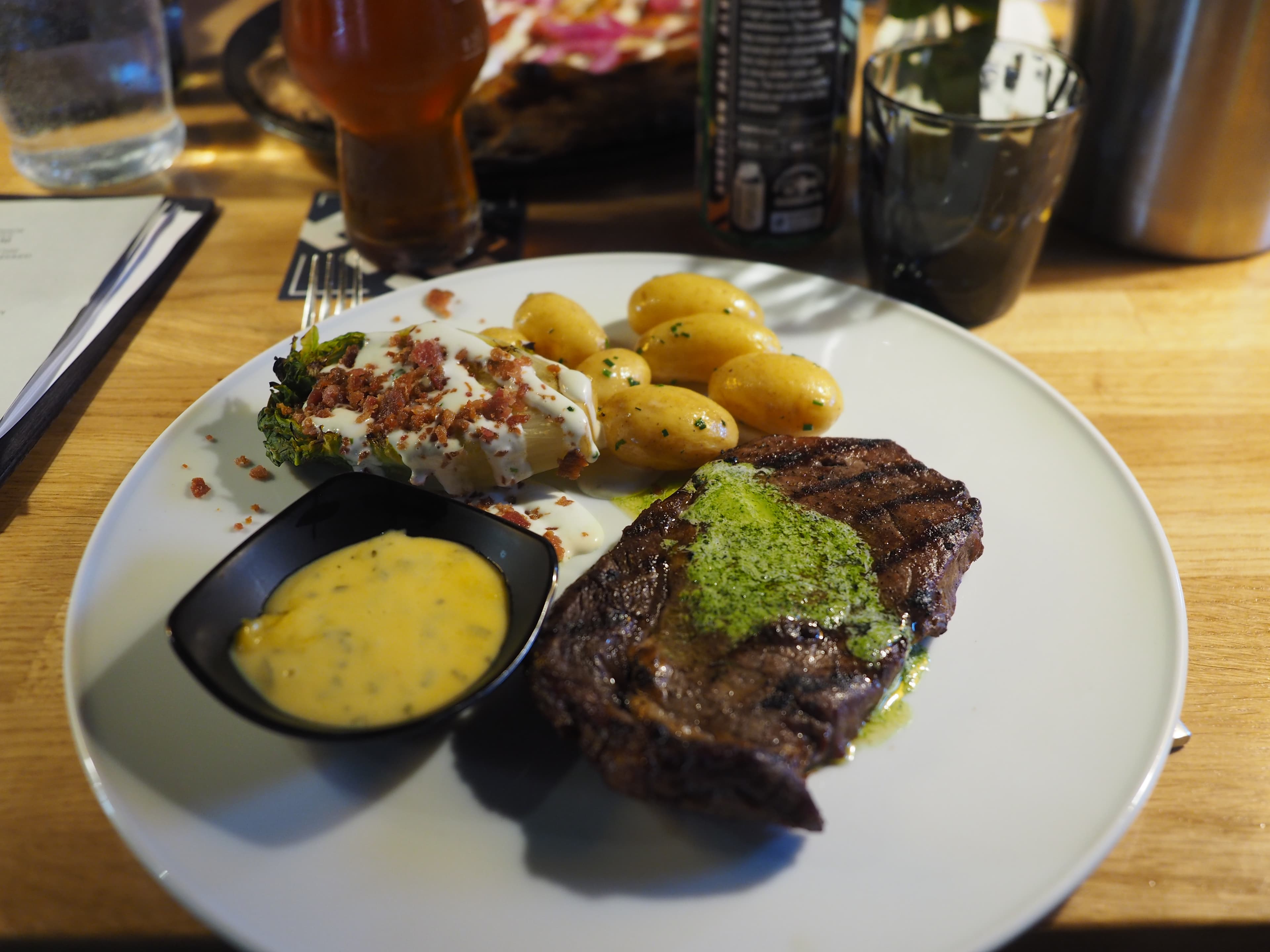 Charcoal-grilled Black Angus entrecôte plated at a restaurant table