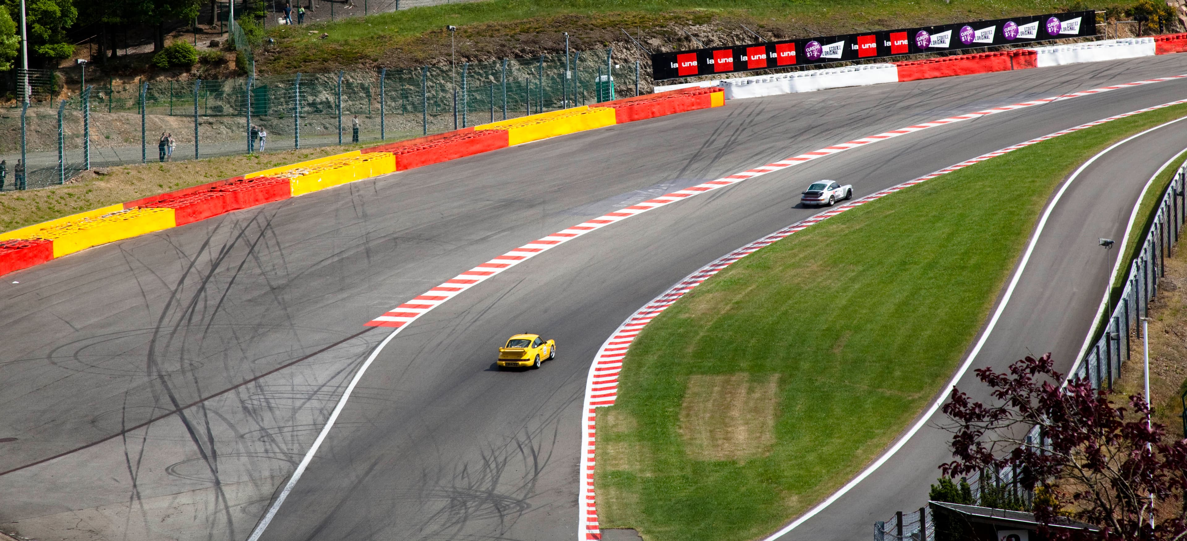 Cars climbing the Raidillon at Spa-Francorchamps, feeding onto the Kemmel Straight — placeholder pending licensed image